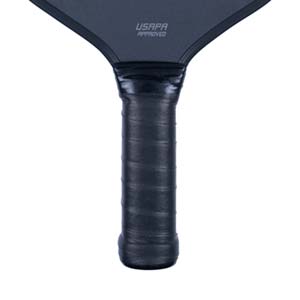 Close-up of a black pickleball paddle with USAPA APPROVED text and a textured grip.