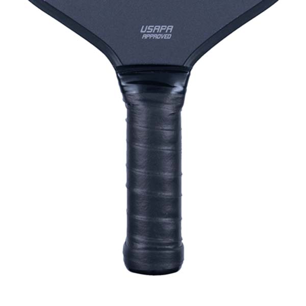 Close-up of a black pickleball paddle grip with USAPA APPROVED text on the paddle head.
