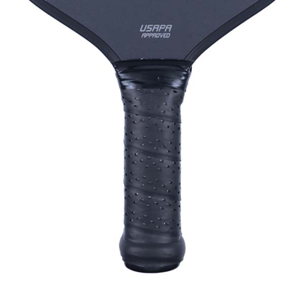 Close-up of a black pickleball paddle grip with textured dots and USAPA APPROVED text.