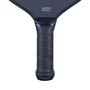 Close-up of a black pickleball paddle grip with textured dots and USAPA APPROVED text.