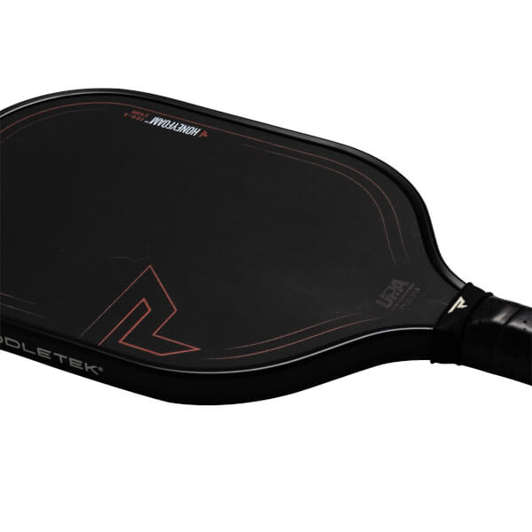 Top-down view of a black pickleball paddle with red accents, showing "HONEYFOAM" and "USA PRO CERTIFIED" text.