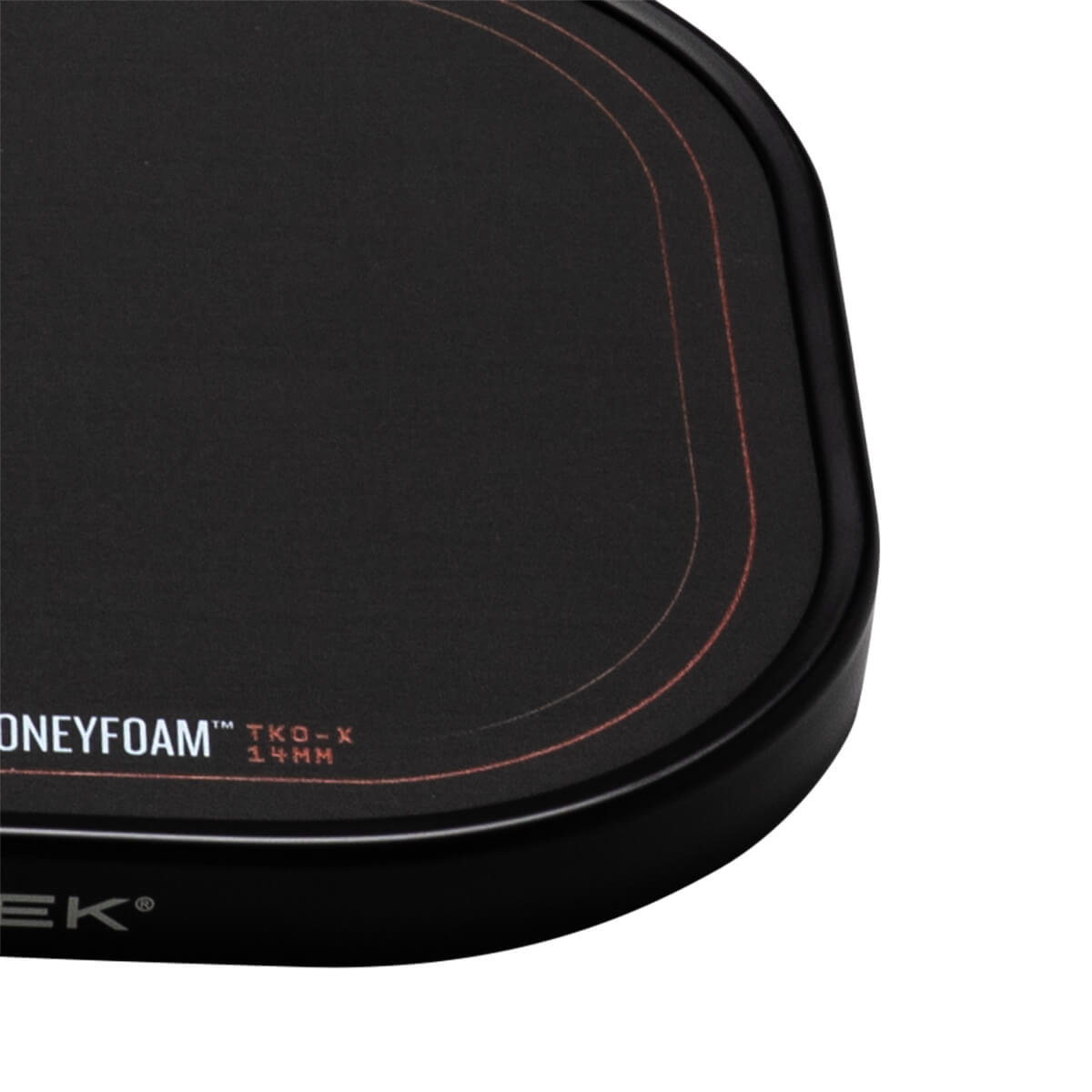 Corner view of a black mousepad with red stitching and "HONEYFOAM" text.