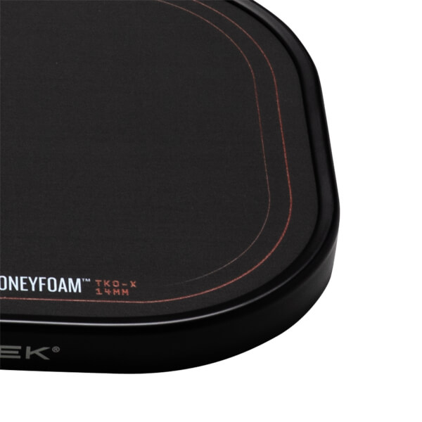 Corner view of a black mousepad with red stitching and "HONEYFOAM" text.