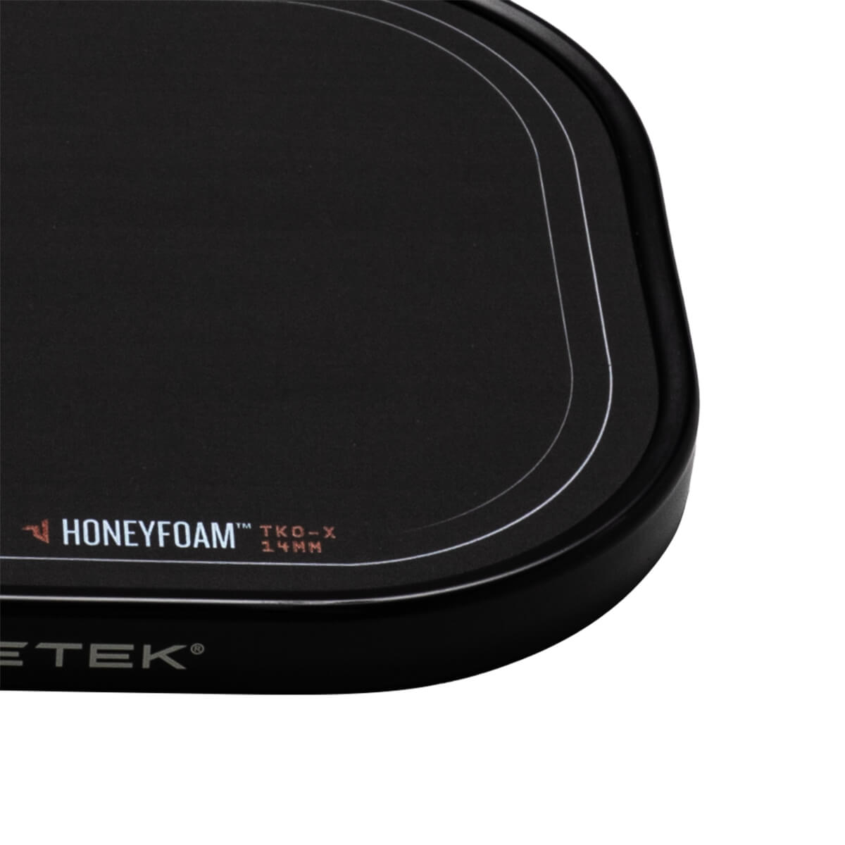 Corner view of a black mousepad with white "HONEYFOAM" and "TKO-X 14MM" text, and a silver "ETEK" logo.