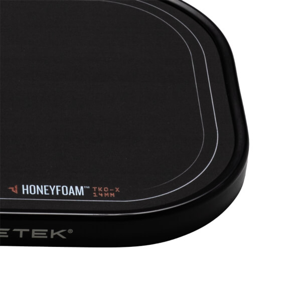 Corner view of a black mousepad with white "HONEYFOAM" and "TKO-X 14MM" text, and a silver "ETEK" logo.