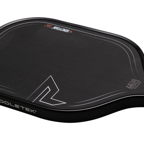 Corner view of a black Paddletek paddle showing the "HONEYFOAM™ TKO-X 16MM" text and a white angular logo.