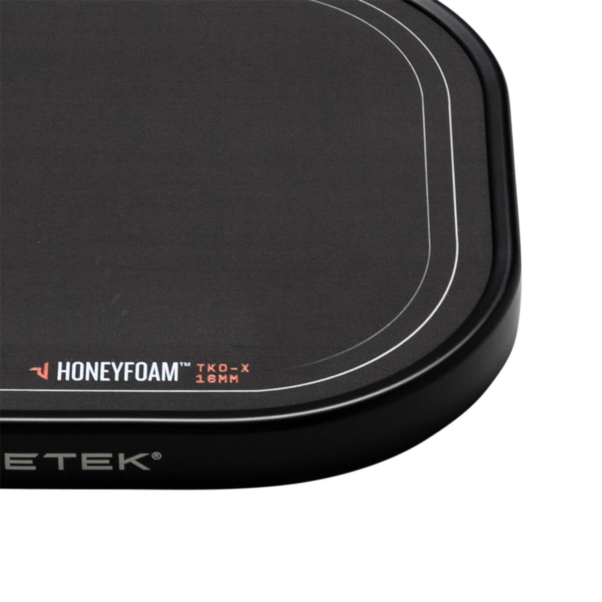 Corner view of the black paddle showing "HONEYFOAM™ TKO-X 16MM" and "PADDLETEK®" text.