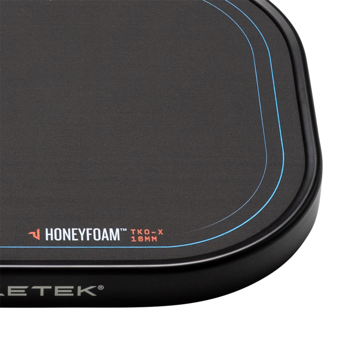 Corner view of a black pickleball paddle with Honeyfoam™ TKO-X 16MM branding and blue accent lines.