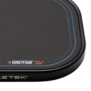 Corner view of a black pickleball paddle with Honeyfoam™ TKO-X 16MM branding and blue accent lines.