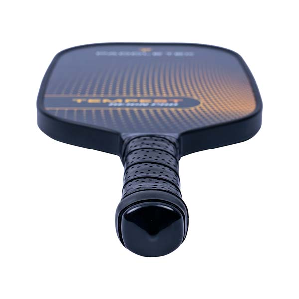 Top-down view of a black pickleball paddle with a textured grip and orange dot pattern.