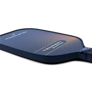 Side view of a dark blue pickleball paddle with PADDLETEK and TEMPEST REIGN PRO text and a dotted gradient design.