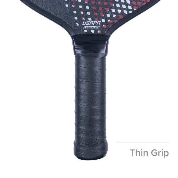 Close-up of a black pickleball paddle grip with USAPA APPROVED text and a red and white dot pattern.