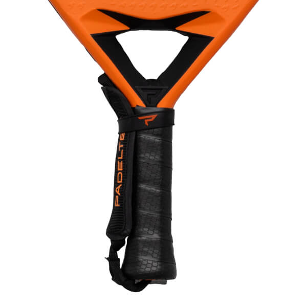 Close-up of a padel racket handle with a black grip, a wrist strap, and the word "PADEL" visible.