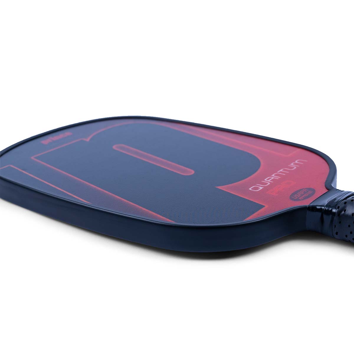 Top-down view of a navy and red pickleball paddle with a large P graphic and QUANTUM PRO text.