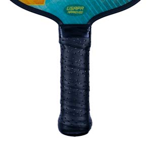 Close-up of a black pickleball paddle grip with USAPA APPROVED text on the teal head.