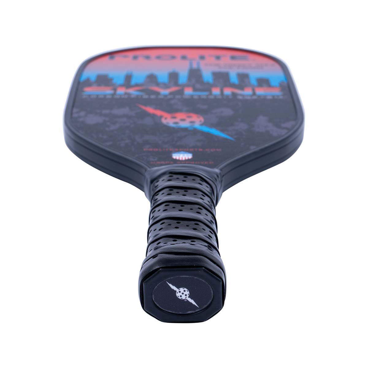Top-down view of a black PROLITE pickleball paddle with a skyline graphic and perforated grip.