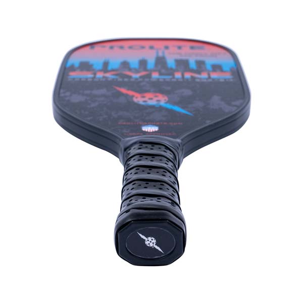 Top-down view of a black PROLITE pickleball paddle with a skyline graphic and perforated grip.