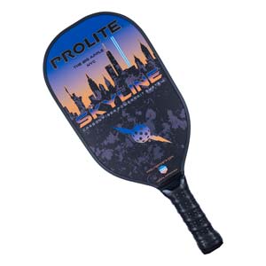 Top-down view of a black pickleball paddle with a NYC skyline graphic, PROLITE and SKYLINE text, and a pickleball graphic.