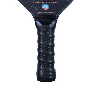 Close-up of a black pickleball paddle grip with perforations and USAPA APPROVED text.