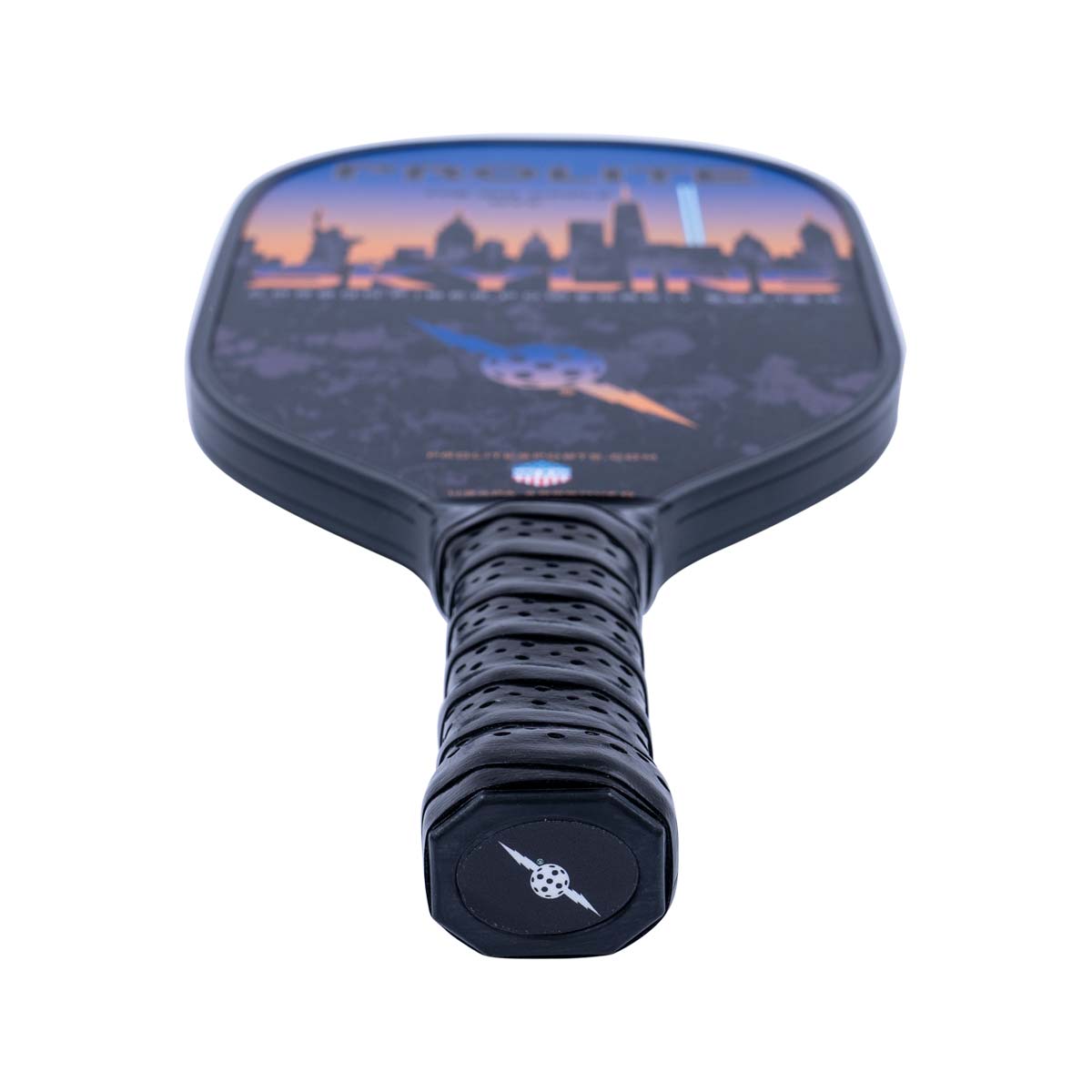 Top-down view of a black pickleball paddle with a city skyline graphic and perforated grip.