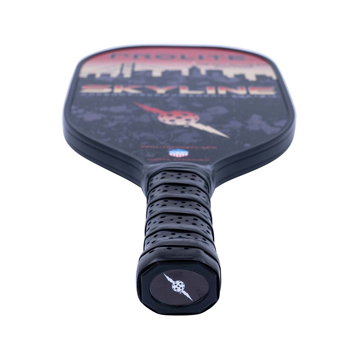 Top-down view of a black pickleball paddle with a skyline graphic and textured grip.