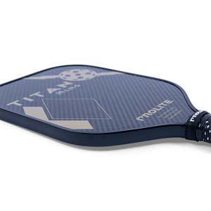 Corner view of a dark blue pickleball paddle with TITAN LRG and PROLITE text, and a diamond pattern.