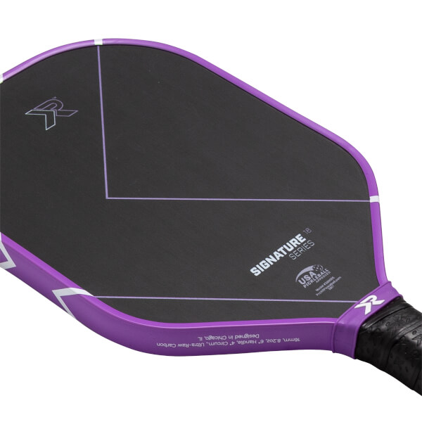 Angled view of a black pickleball paddle with a purple edge, SIGNATURE SERIES text, and white R logo.