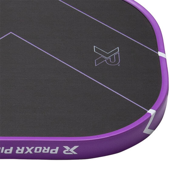 Close-up of a dark gray pickleball paddle face with purple diagonal lines, an XR logo, and a purple edge guard with ProXR Pi text.