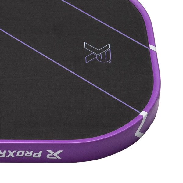 Close-up of a black pickleball paddle with a textured surface, purple edge guard, and XR logo.