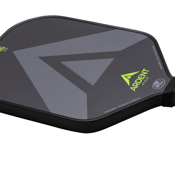 Close-up of a black pickleball paddle showing a grey V-shaped graphic, the "ARDENT" logo, and "USA PICKLEBALL APPROVED".