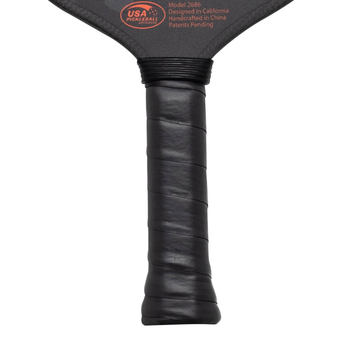 Close-up of a pickleball paddle handle wrapped in black grip tape, showing "USA PICKLEBALL APPROVED" text.