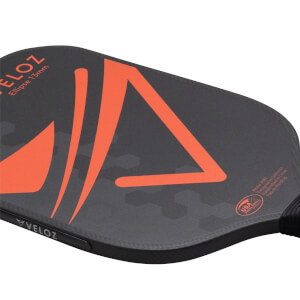 Corner view of a black pickleball paddle with orange VELOZ branding and a "USA Pickleball Approved" logo.