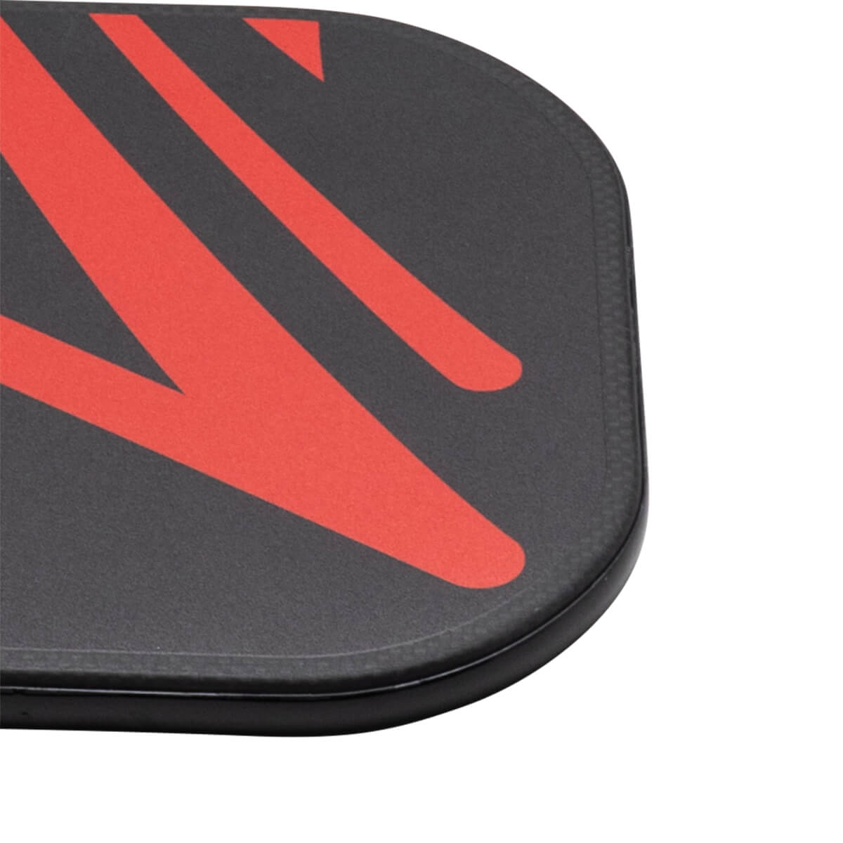 Corner view of the ProXR x Veloz Quadra paddle showing red graphic design on black carbon fiber surface.