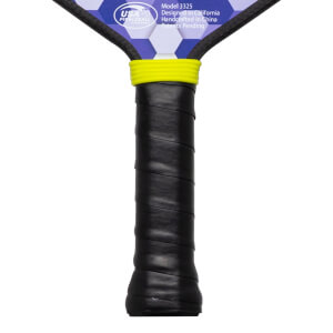 Close-up of pickleball paddle handle with black grip, yellow band, and "USA Pickleball Approved" logo.
