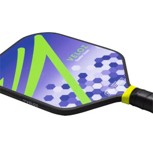 Corner view of a pickleball paddle with a blue and purple hexagonal pattern, a lime green "V" shape, and "VELOZ" text.