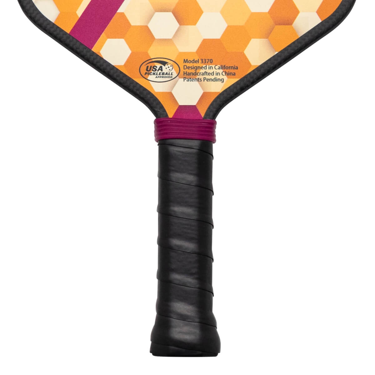 Close-up of the handle and lower paddle face, showing a black grip, purple band, and honeycomb pattern with "USA Pickleball Approved" logo.