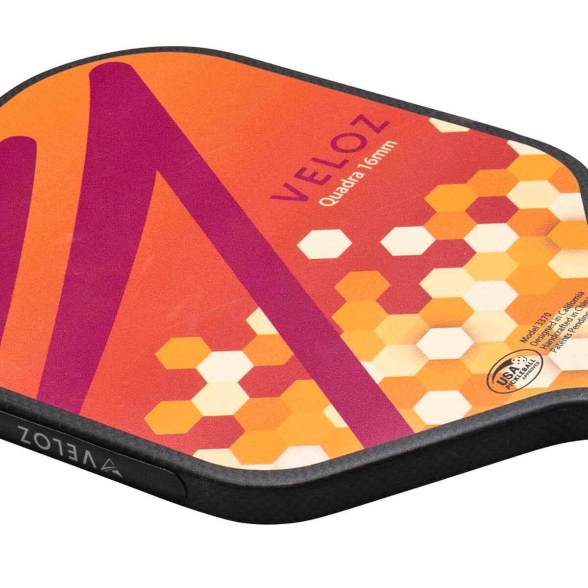 Top-down view of a pickleball paddle with orange and purple geometric patterns, the word VELOZ, and a USA Pickleball Approved logo.