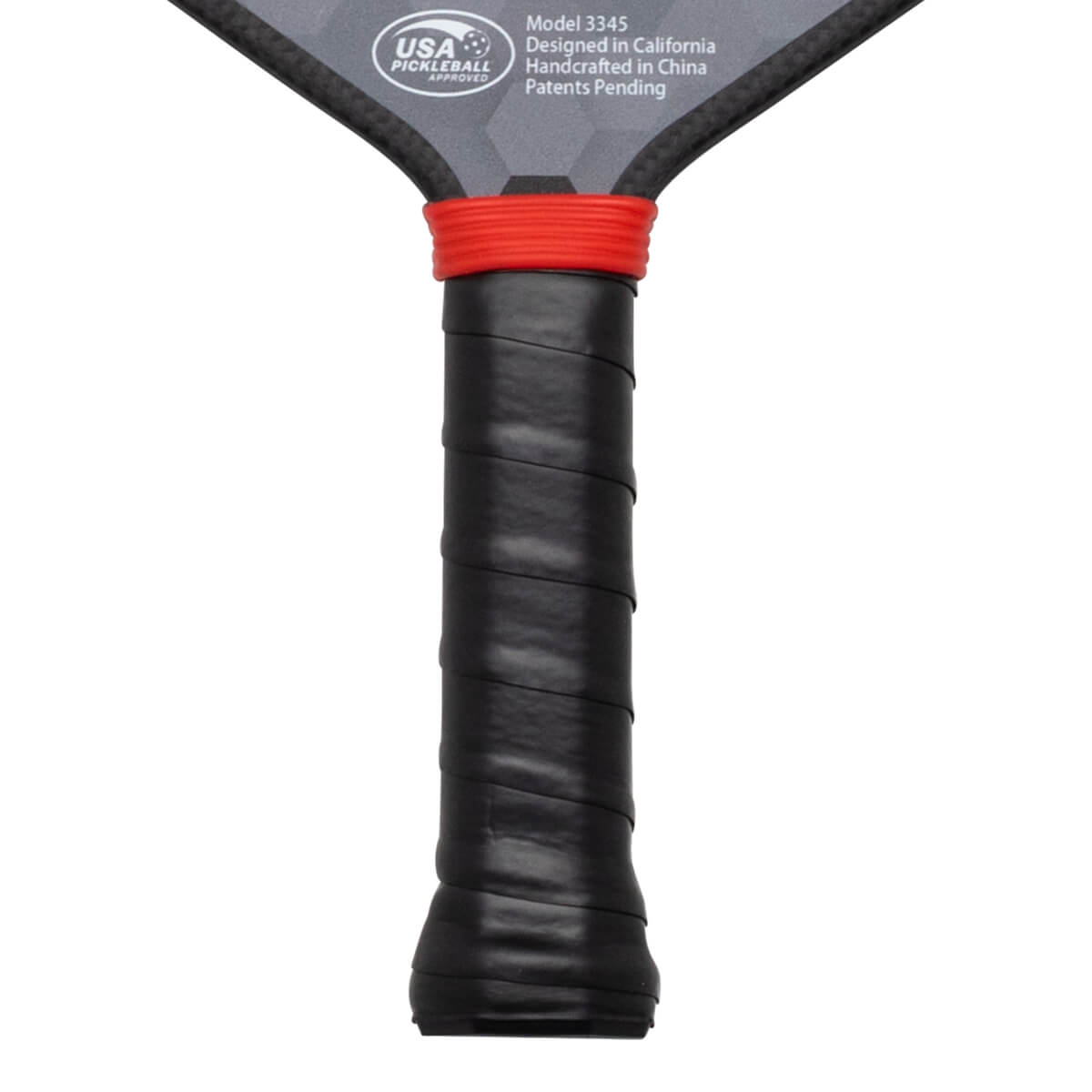 Close-up of the grip showing black textured wrap and a red band above it, with "USA PICKLEBALL APPROVED" visible.