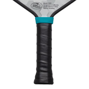 Close-up of a pickleball paddle handle with black grip tape and a teal band, showing "USA PICKLEBALL APPROVED" and "Model 3305".