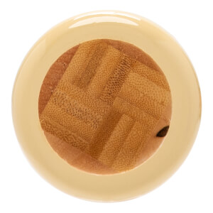 Top-down view of the glossy light beige end of a baseball bat, revealing a textured natural wood core with a small dark hole.