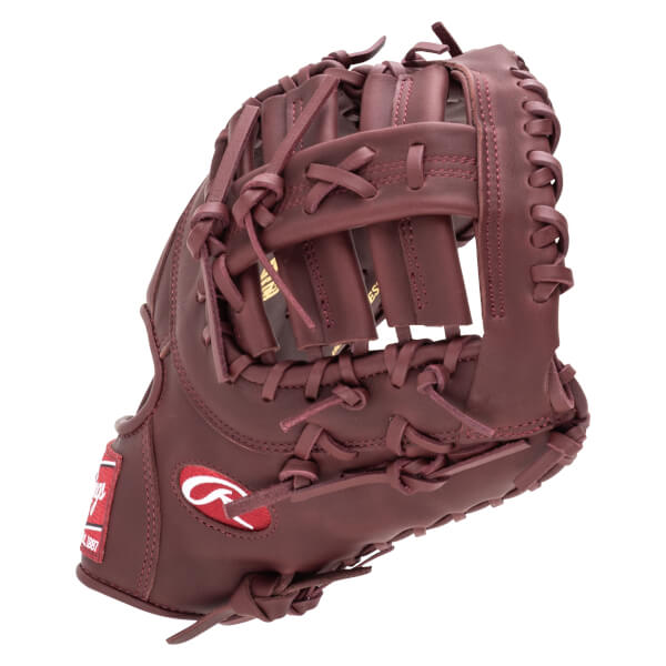 Side view of a maroon baseball glove with a red Rawlings logo and "EST. 1887" visible.