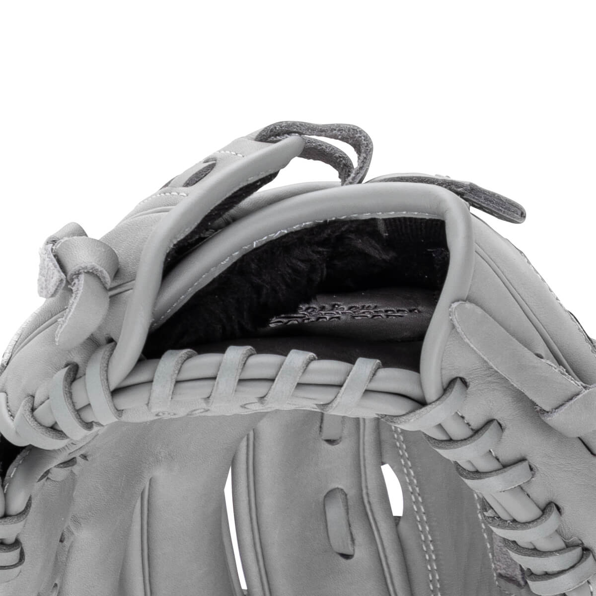 Close-up of a gray baseball glove showing the lacing and interior lining.