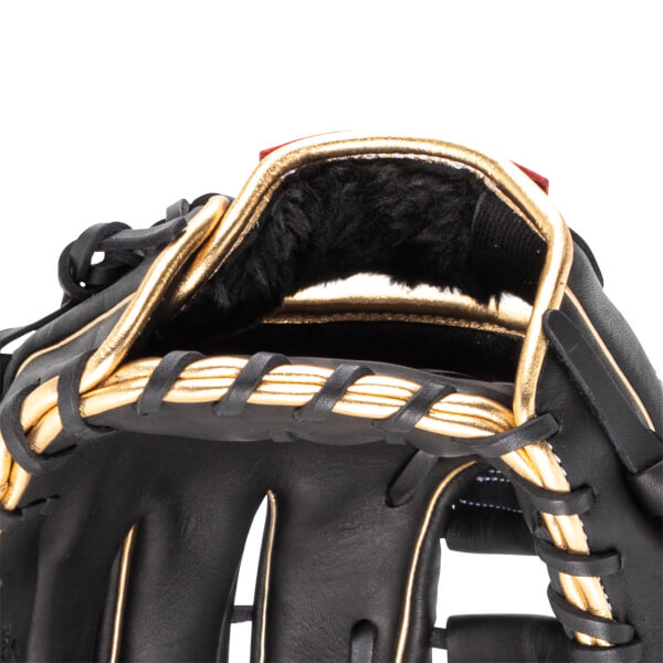 Close-up of the interior of a black baseball glove with gold trim and black fur lining.