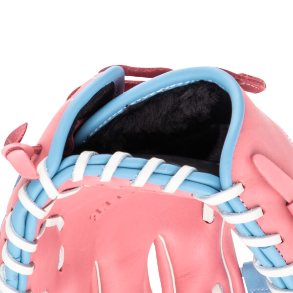 Close-up of a pink baseball glove with light blue binding and white lacing.
