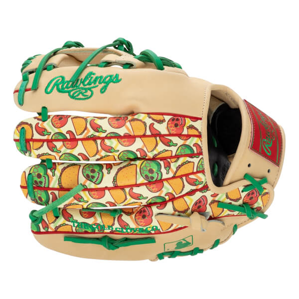 Back view of a tan Rawlings baseball glove featuring green laces and a vibrant taco, pepper, and skull pattern with visible text Rawlings and THE GOLD GLOVE CO.