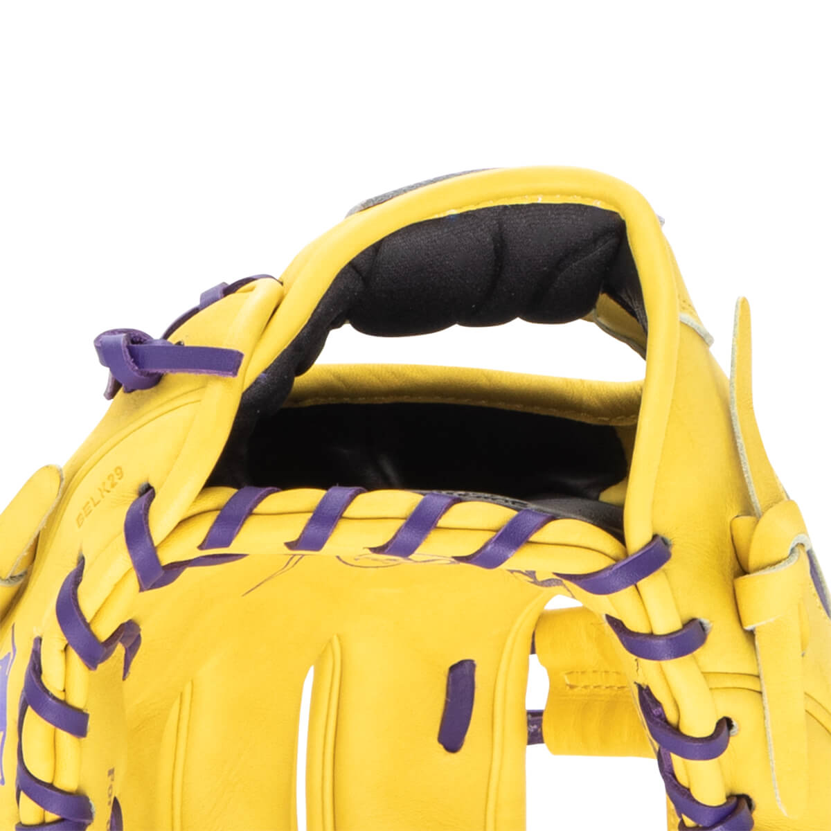 Close-up of a yellow baseball glove with purple lacing and "BELK29" embossed on the leather.