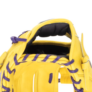 Close-up of a yellow baseball glove with purple lacing and "BELK29" embossed on the leather.