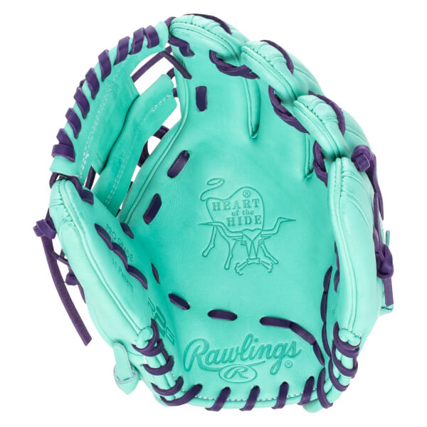 Top-down view of a teal baseball glove with purple lacing, featuring the "Rawlings" logo and "Heart of the Hide" emblem.