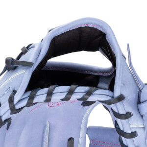 Close-up of the interior of a lavender baseball glove, showing black lacing and pink stitching.