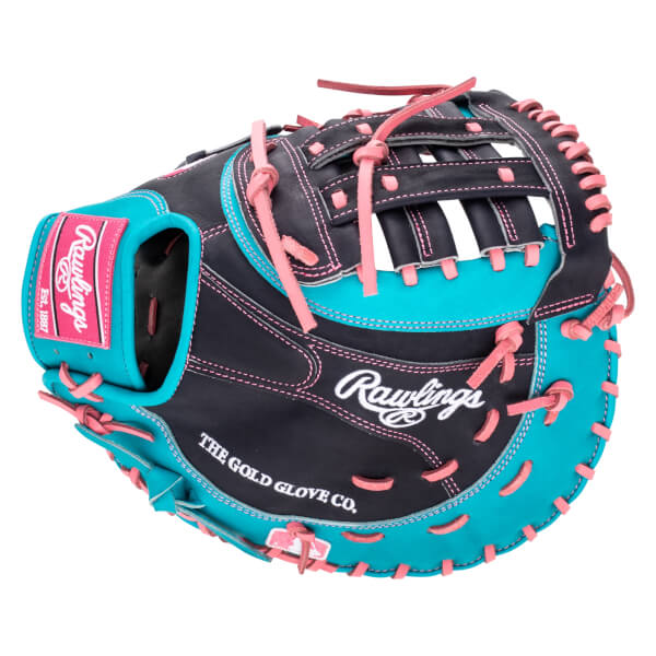 Side view of a black and teal Rawlings baseball glove with pink stitching and laces, showing the "Rawlings" logo and "THE GOLD GLOVE CO." text.